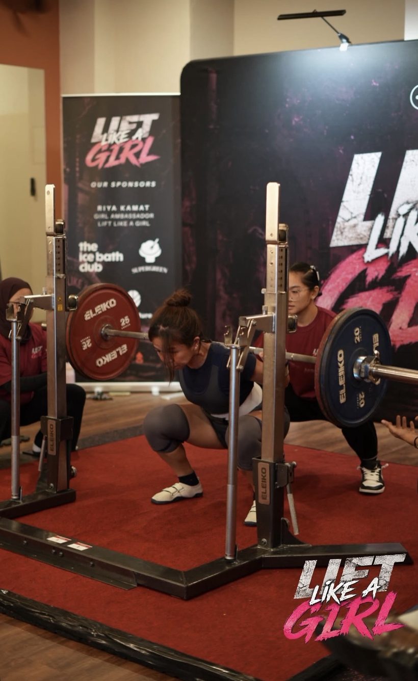 Patricia squatting in a powerlifting competition at a Lift Like A Girl meet.